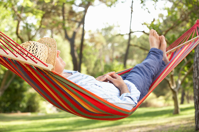 Guy relaxing in a hammock