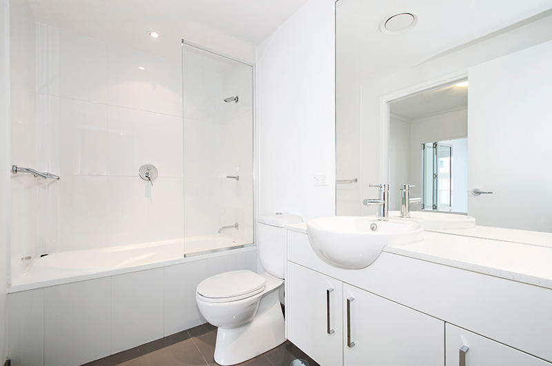 Modern bathroom in white with tub and glass screen